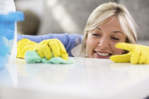Local cleaner treating a corner sofa in Brent property